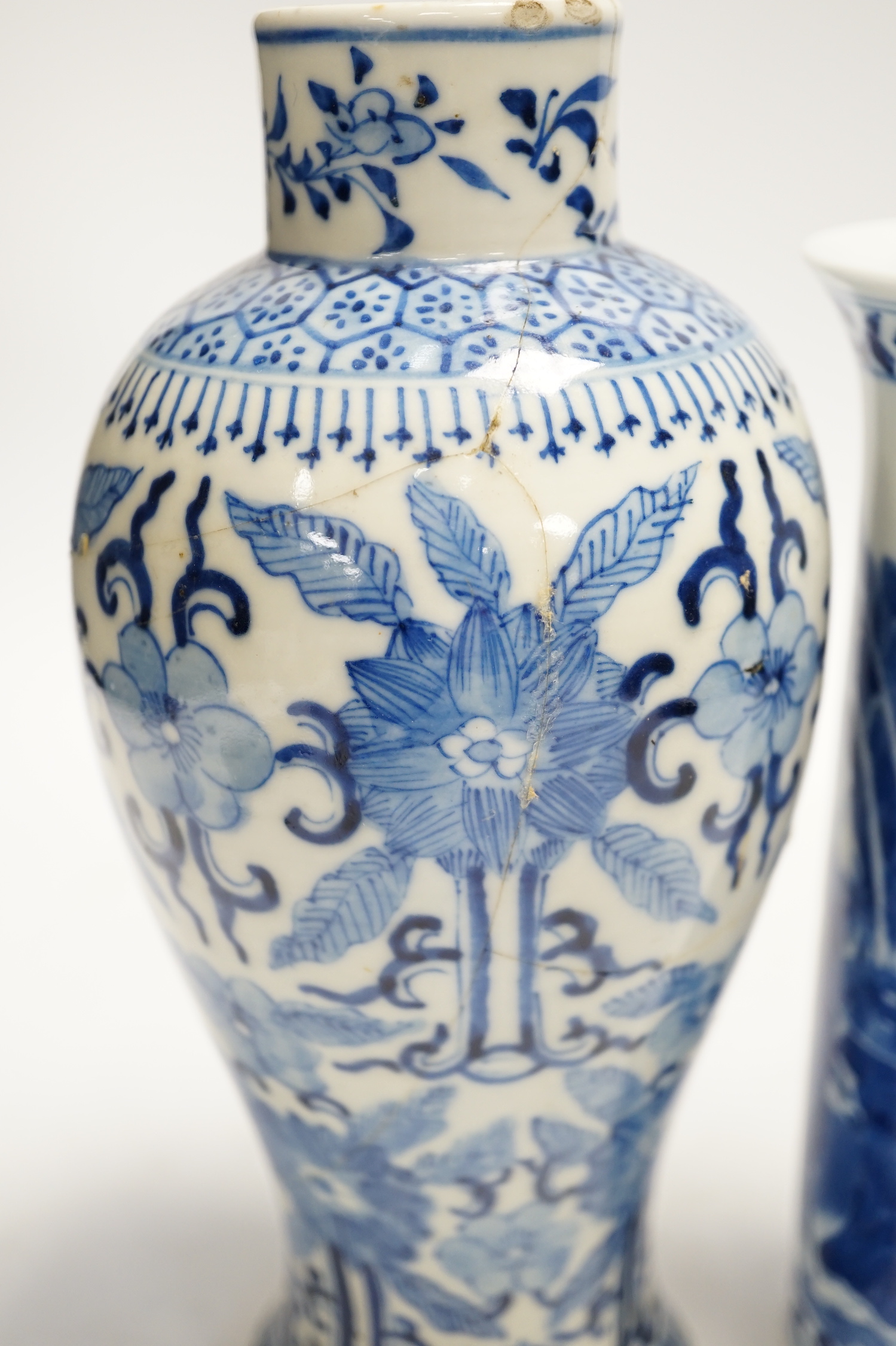 Two early 20th century Chinese blue and white vases, one restored, 23cm